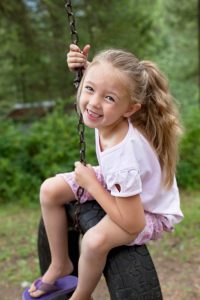 Girl on Backyard Tire Swing