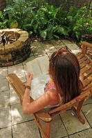 woman sitting in chair by firepit