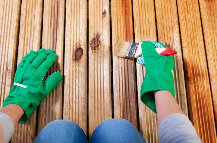 Woman staining deck