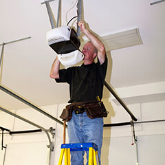 man fixing a garage door opener