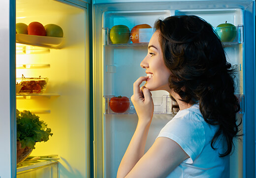 Woman looking in her refrigerator