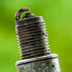 lawn mower spark plug that is dirty and in need of cleaning