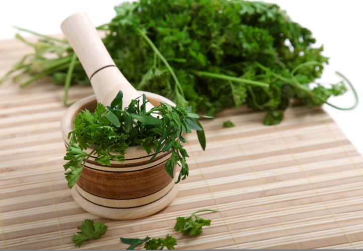 Bowl of cilantro on table