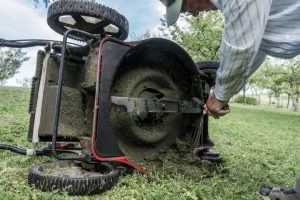 Lawn mower blades covered with grass