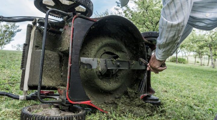 Lawn mower blades covered with grass