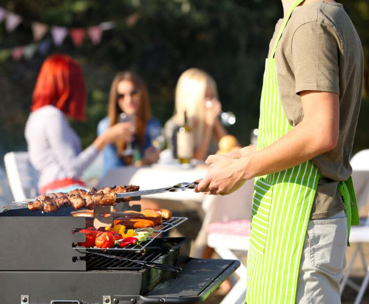 Friends having outdoor barbeque