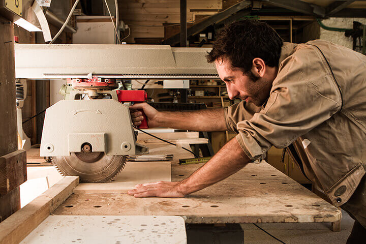 man cutting wood