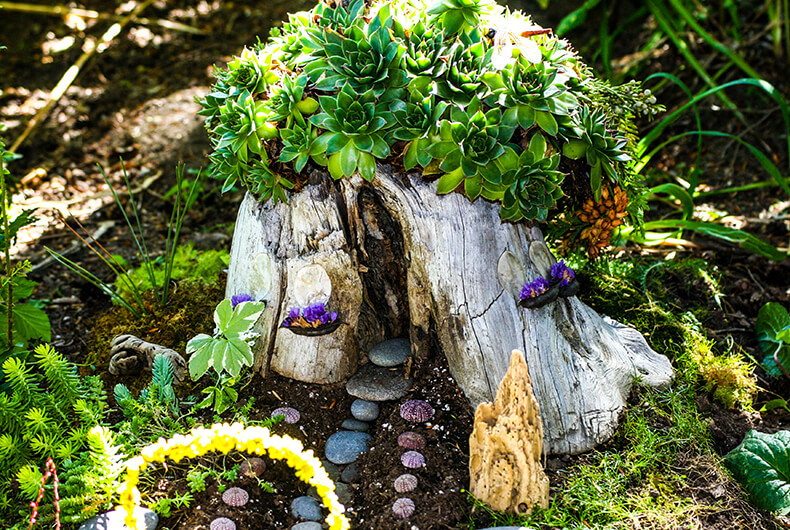 small fairy village made out of a tree stump