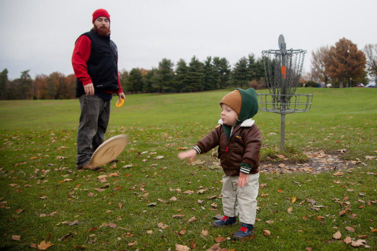 Father and young son playing frisbee golf