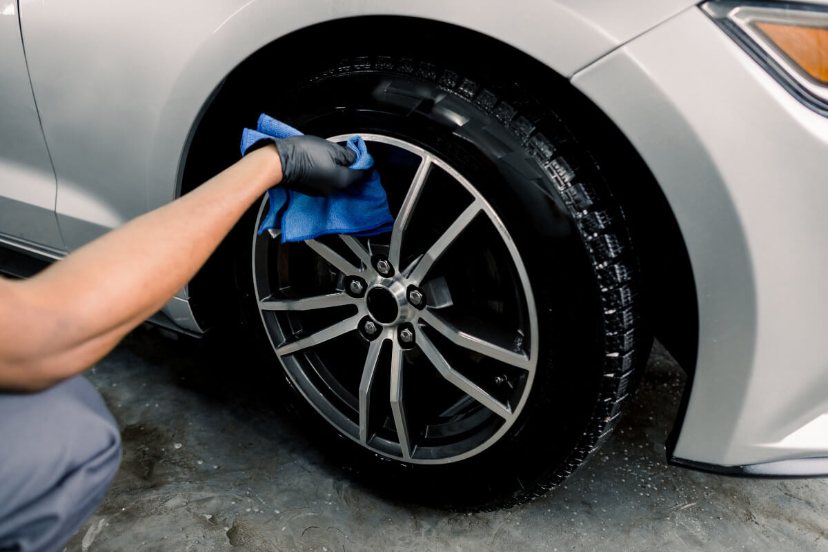 finishing the cleaning of a car's rim and tire