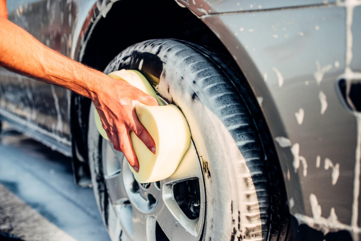 washing car rims with a sponge