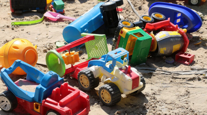 children's toys scattered outside in play area