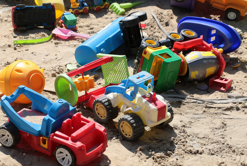 children's toys scattered outside in play area